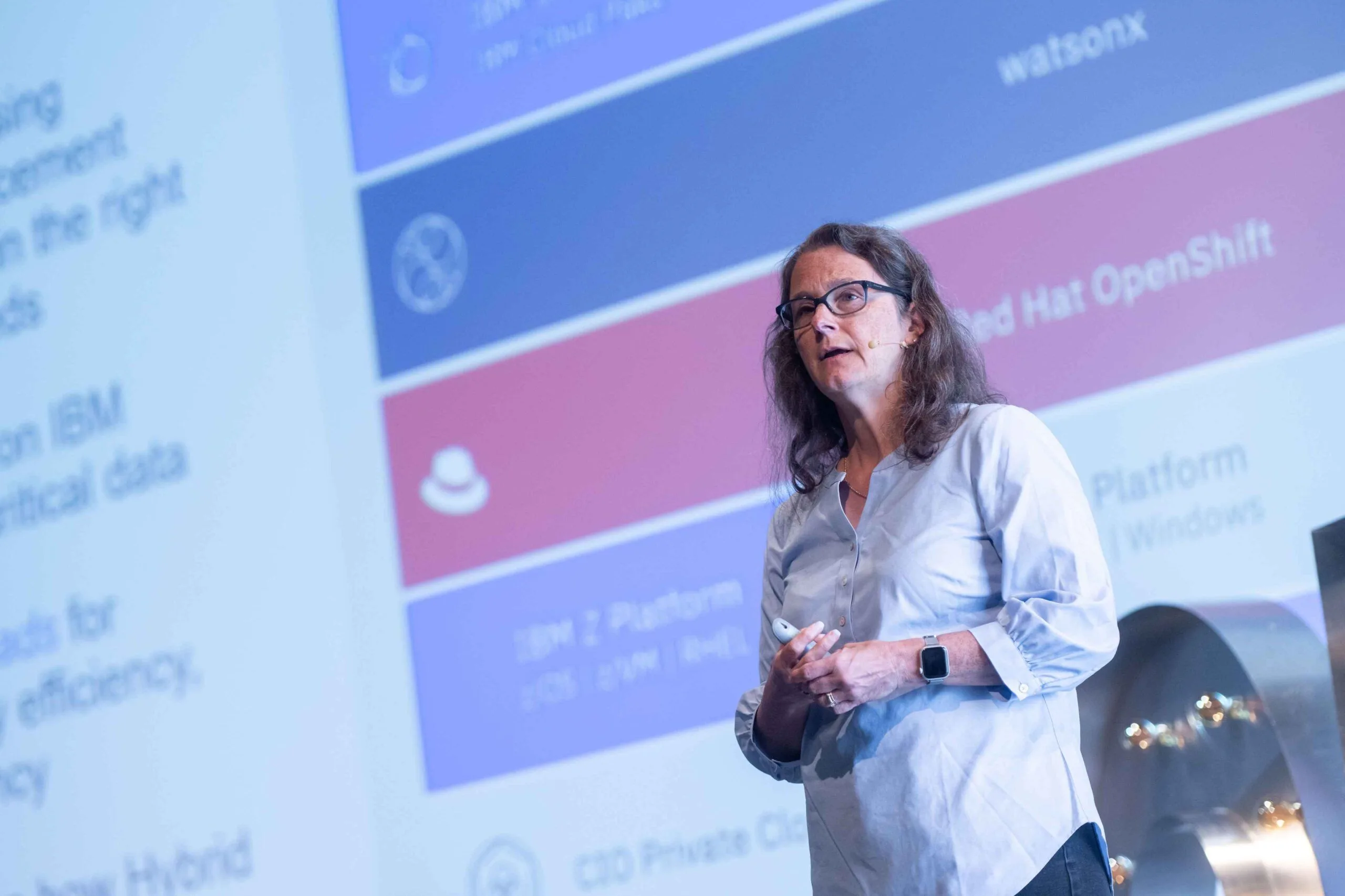 Rosalind Radcliffe on stage in front of a slide about IBM Z and Red Hat OpenShift